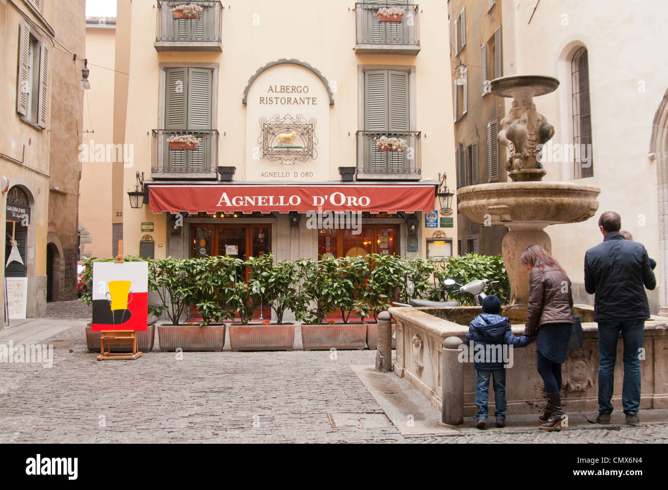 Town square in Bergamo Italy with shops & fountain Stock Photo Alamy