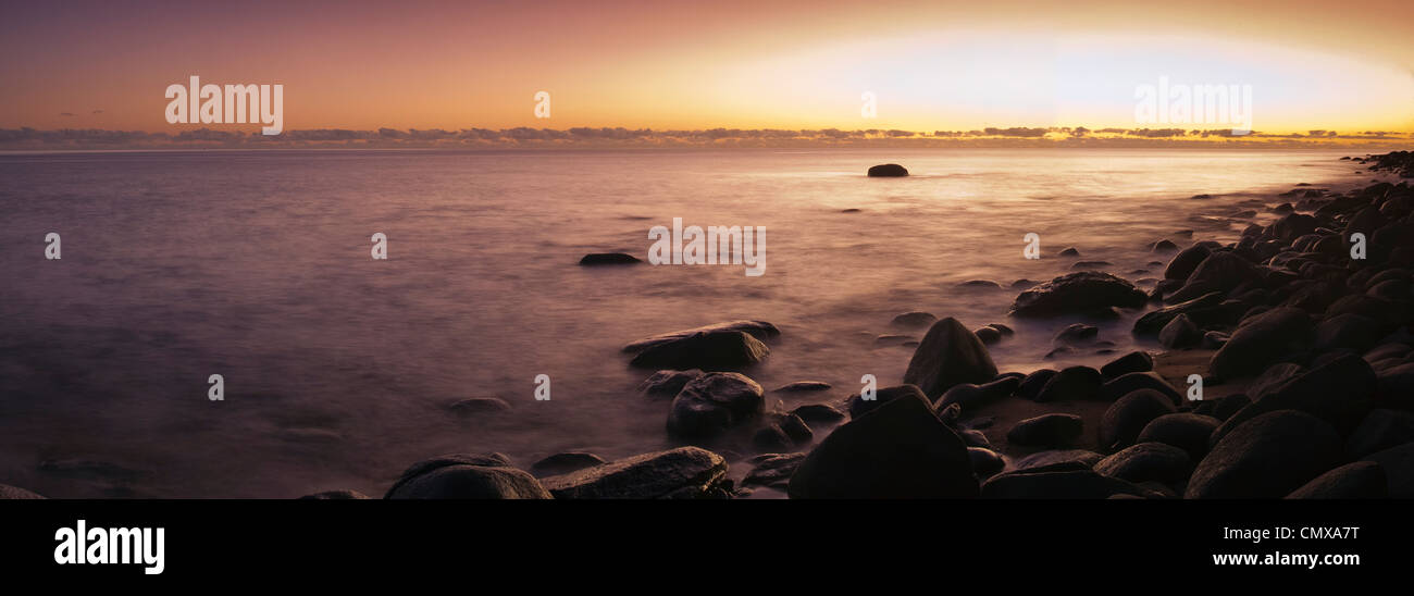 Dawn over the Coral Sea at Pebbly Beach, near Cairns, Queensland, Australia Stock Photo