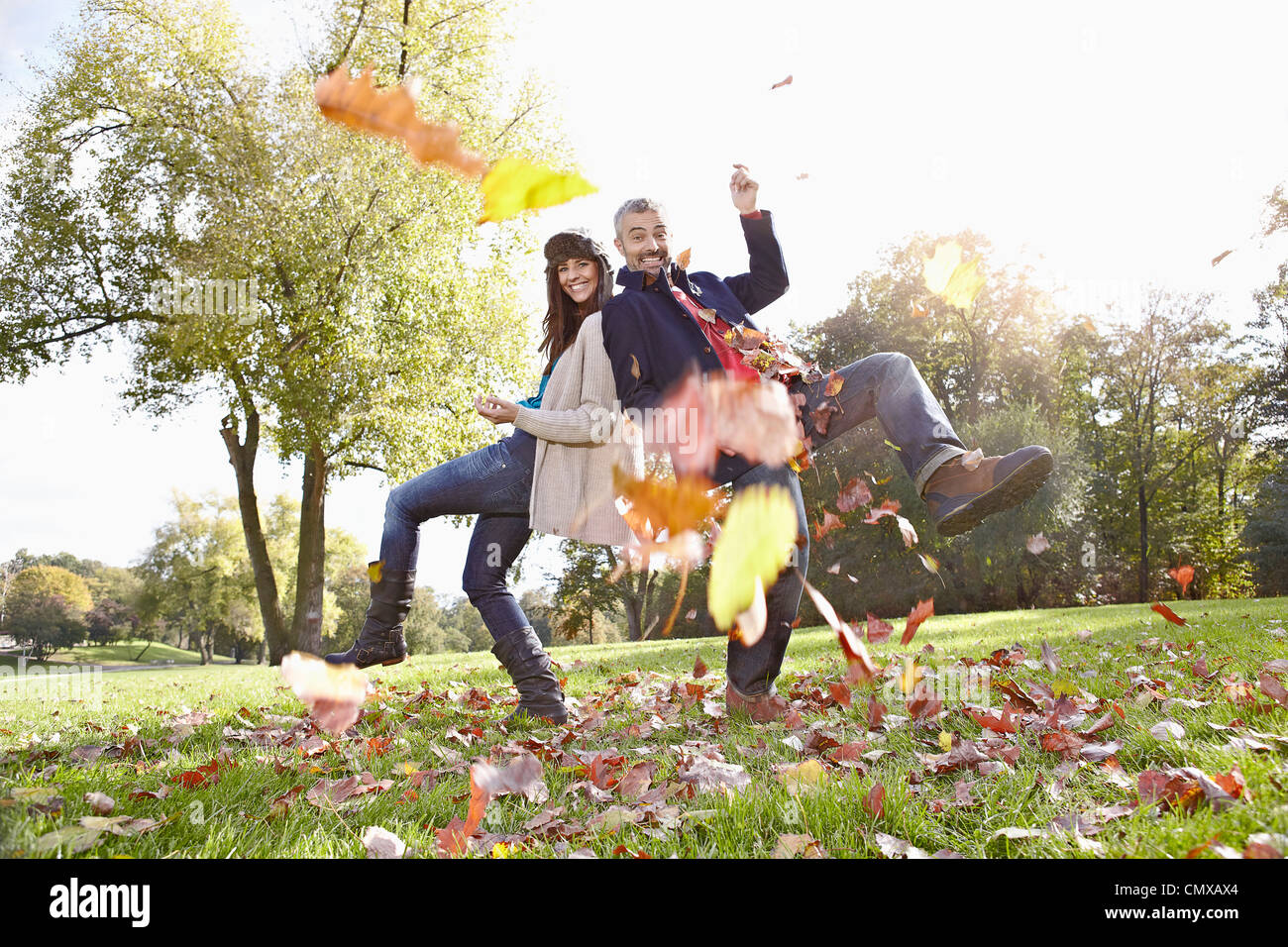 Germany, Cologne, Couple playing in park, smiling, portrait Stock Photo