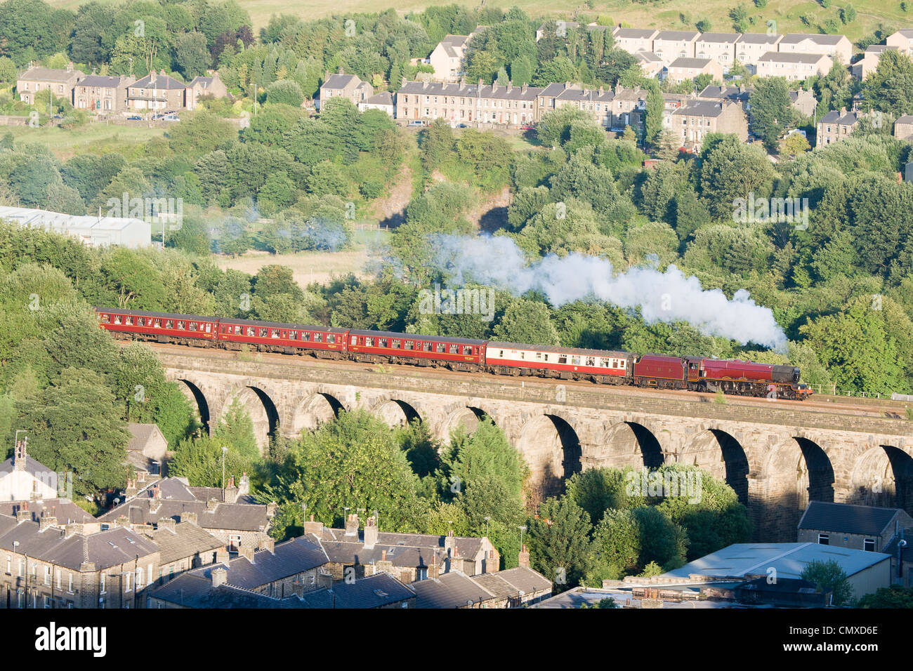 Steam locomotive pulling a passenger train on the mainline at Slaithwaite viaduct, West Yorkshire Stock Photo