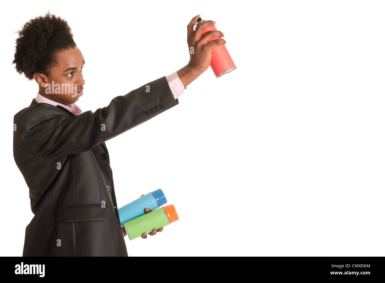 Studio portrait of a young African American man with graffiti aerosols Stock Photo