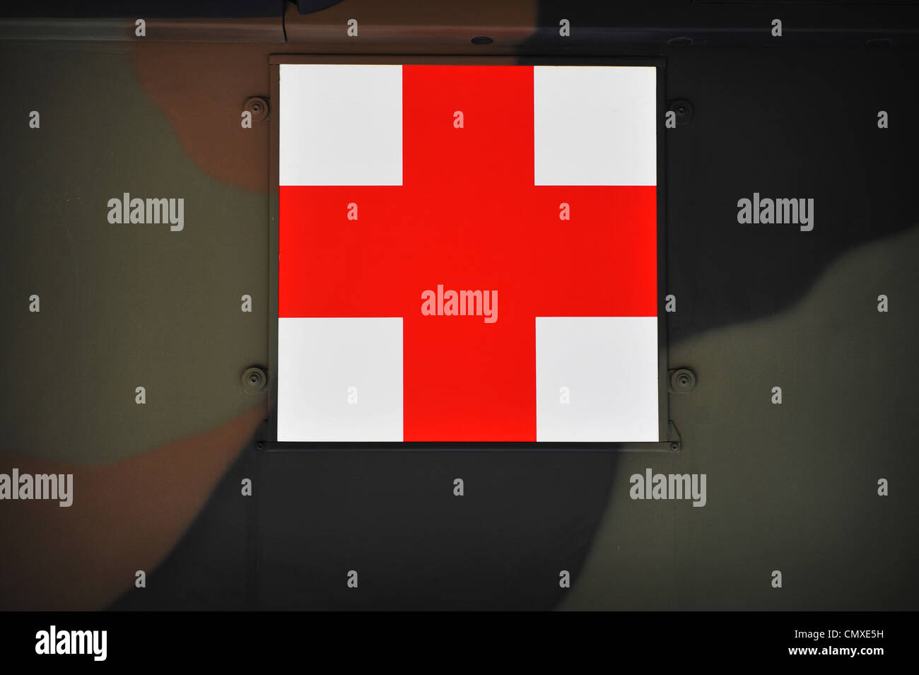 Red Cross international symbol for first aid, hanging outside a military truck Stock Photo