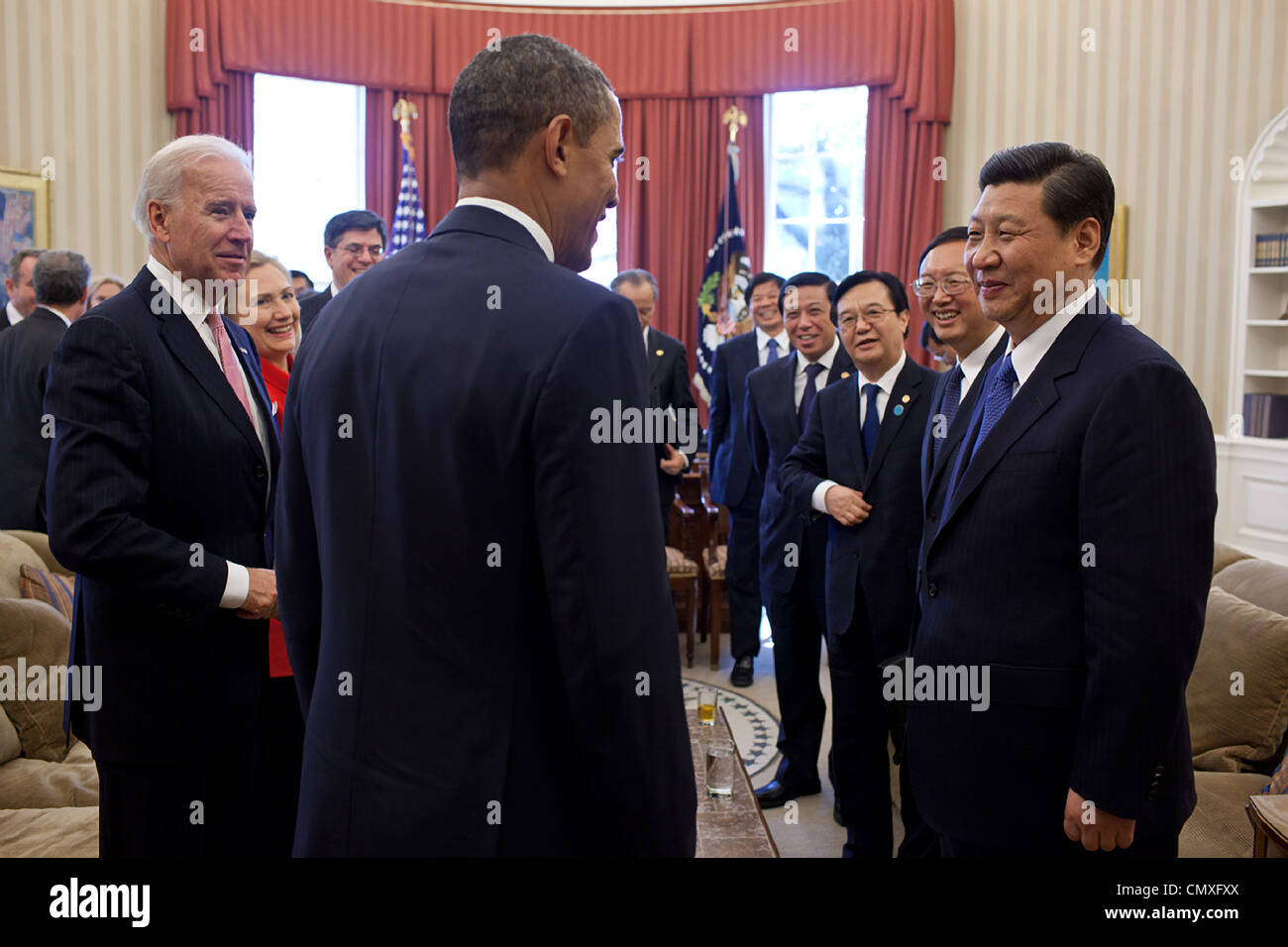 President Barack Obama and Vice President Joe Biden talk with Vice President Xi Jinping of the People’s Republic of China and members of the Chinese delegation following their bilateral meeting in the Oval Office February 14, 2012 in Washington, DC. Stock Photo
