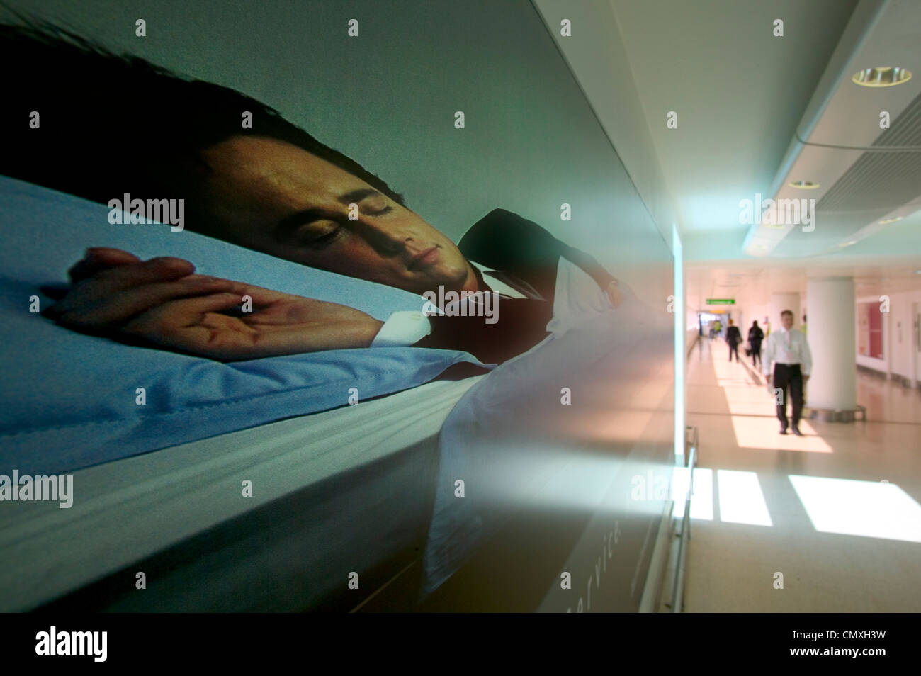Corridor in Heathrow airport lined with first class, business class advertisement for sleep