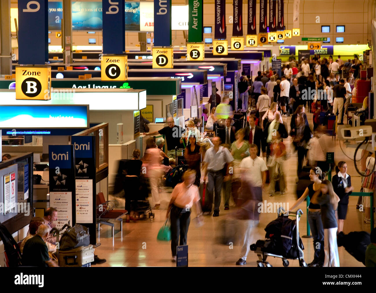 Busy check-in counters in departures lounge at heathrow airport Stock Photo