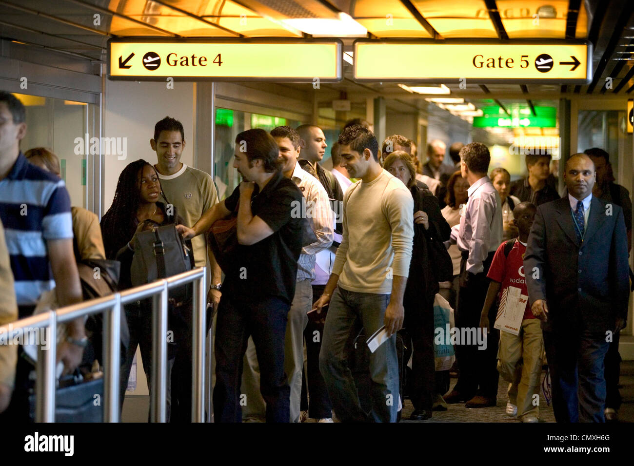 passengers queuing to board flights at heathrow airport Stock Photo