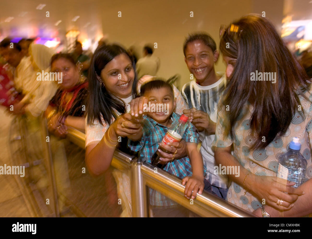 Family waiting at arrivals lounge at Heathrow airport Stock Photo