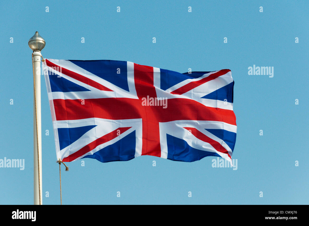 The Union Jack or Union Flag flying against a blue sky. Stock Photo