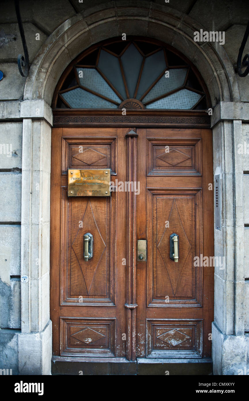 Bright, brown wood doors of an old, stone building in Europe. Stock Photo