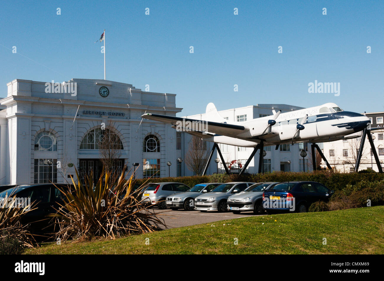 An aircraft spanning the entrance to Airport House, the original terminal building for the old Croydon Airport. Stock Photo