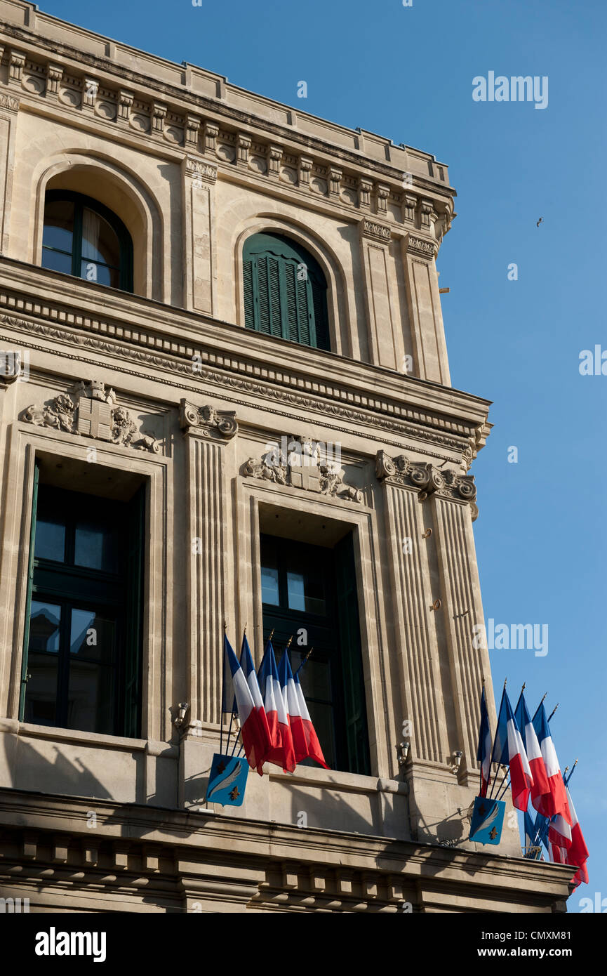 French flags on the outside corner of a European building. Stock Photo
