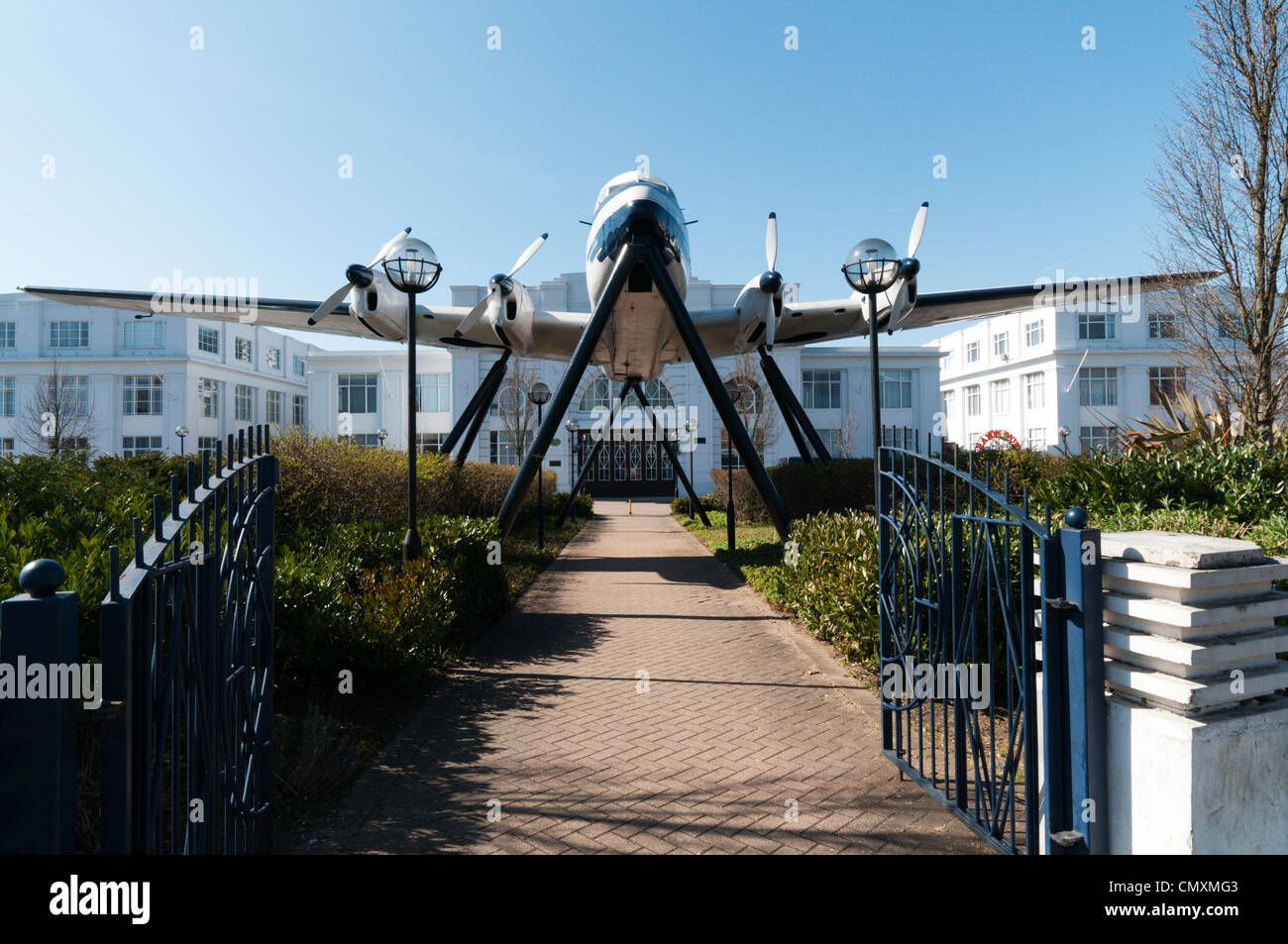 An aircraft spanning the entrance to Airport House, the original terminal building for the old Croydon Airport. Stock Photo