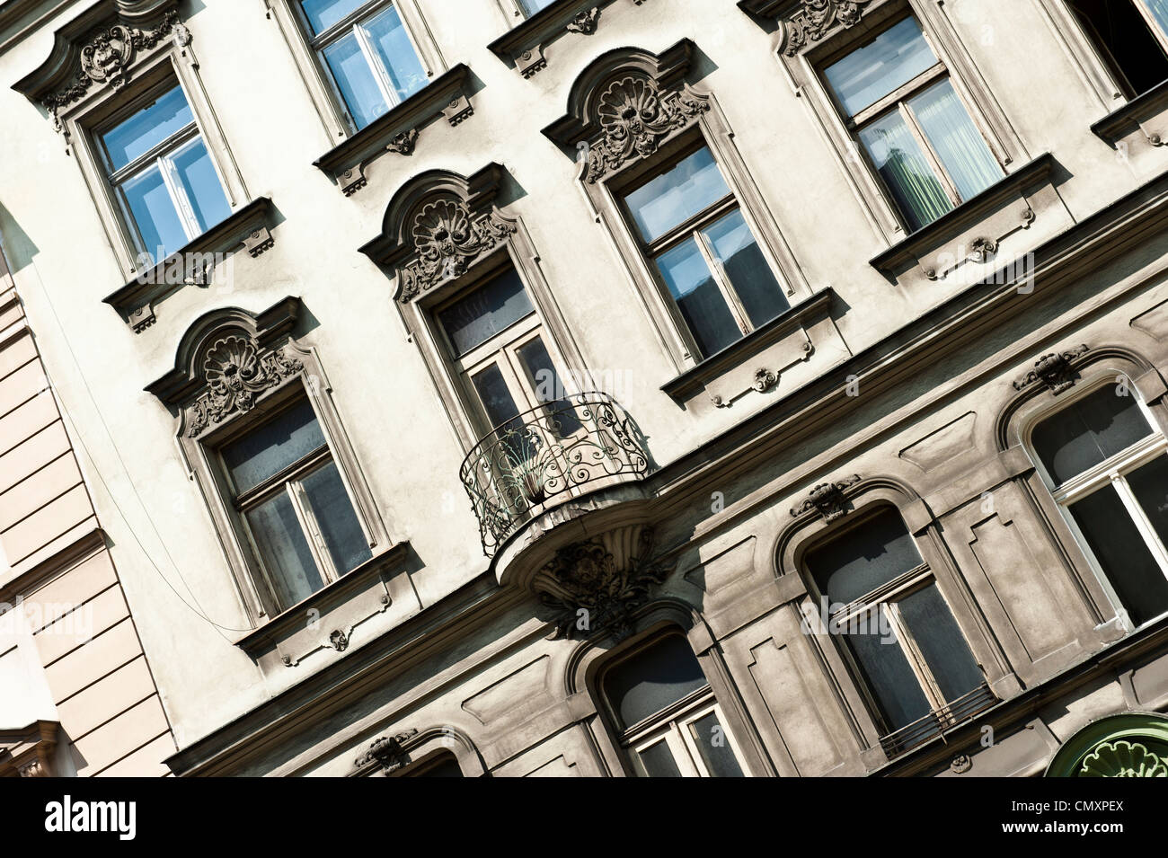 A slanted view of windows to a beige building. Stock Photo
