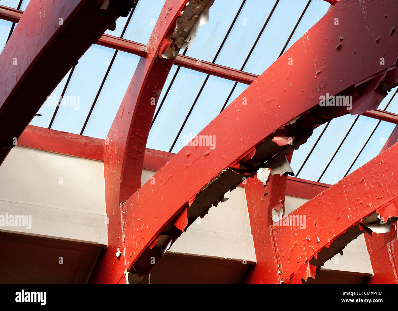 Red paint peels from the steel beams holding up the derelict Govanhill
