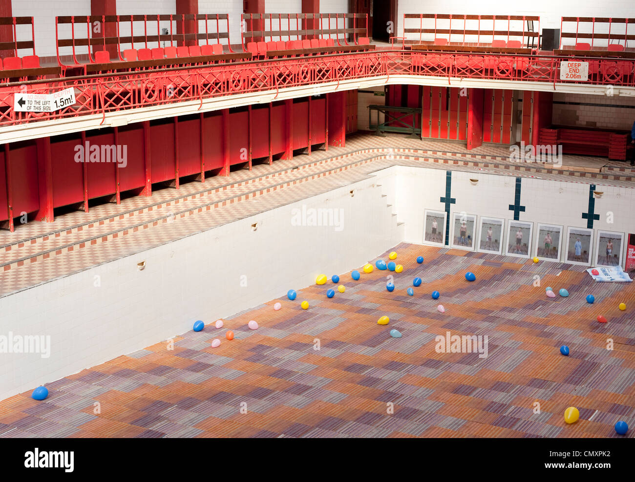 The main swimming pool of the Govanhill Baths in Glasgow is carpeted with balloons in the basin. Stock Photo