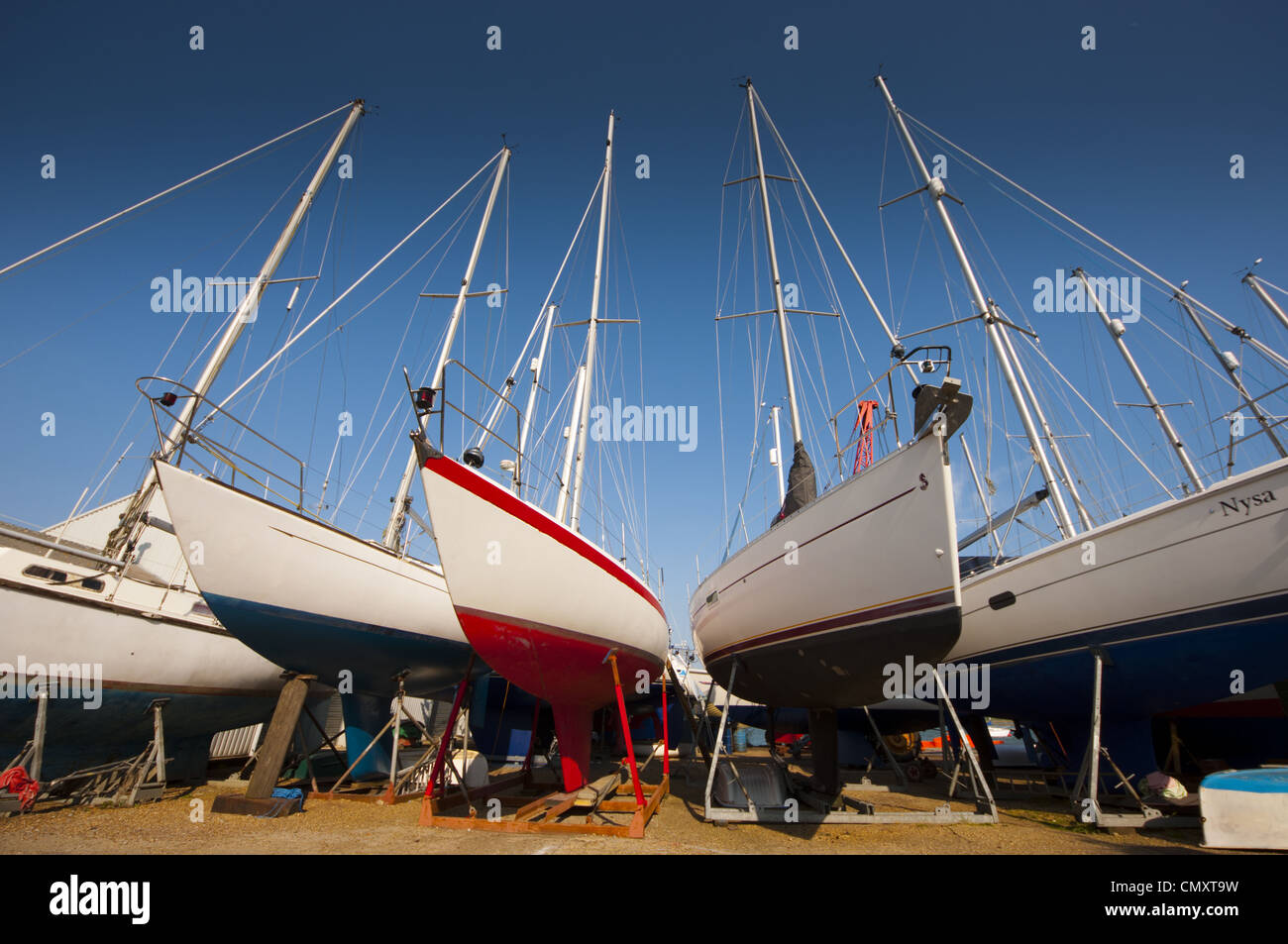 sailing yacht laid up in cradles in boat yard for winter storage Stock