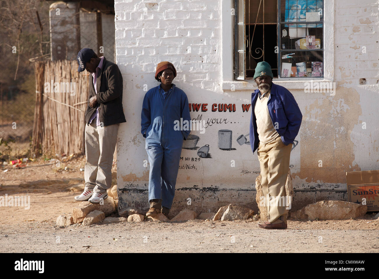 Adult men standing by the shop, Zimbabwe Stock Photo
