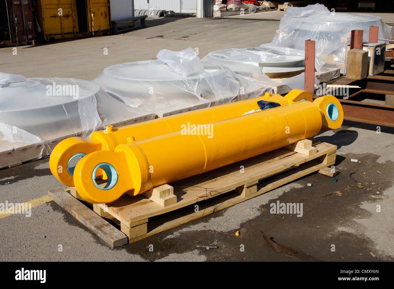Two yellow hydrocylinders are on the pallet Stock Photo