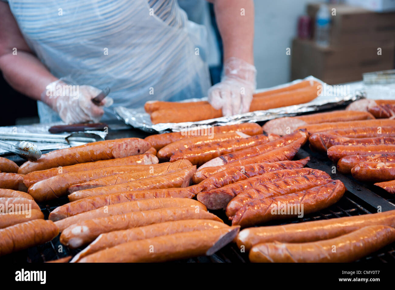 Chef preparing bratwursts for cooking. Stock Photo