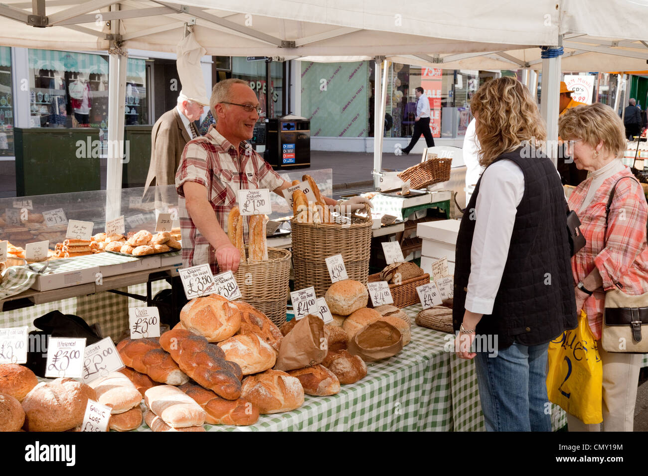 People buying bread at the bakers stall, the Bury St Edmunds market