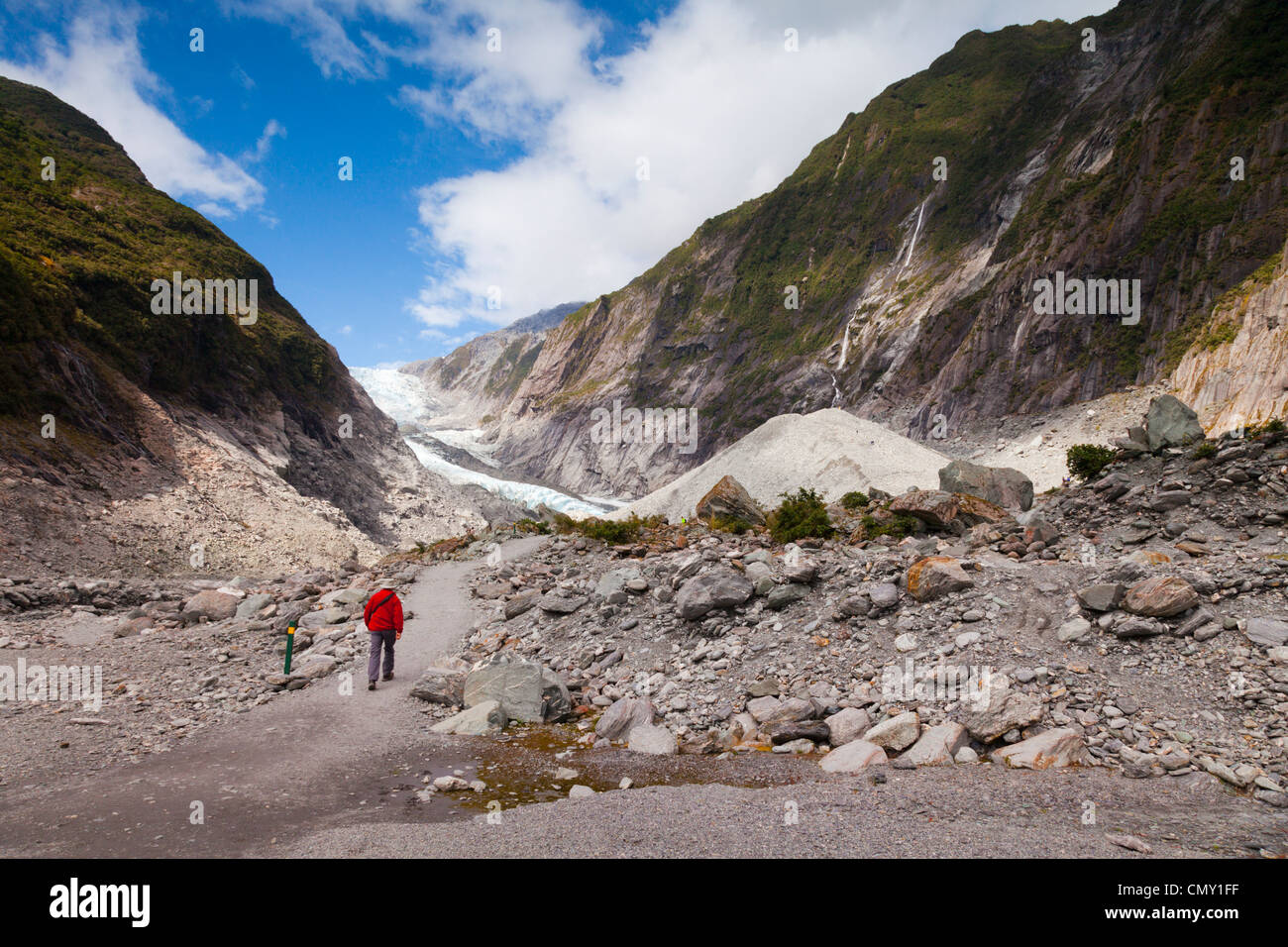 Man walking up track to Franz Josef Glacier, West Coast, New Zealand. Model release available for man. Stock Photo