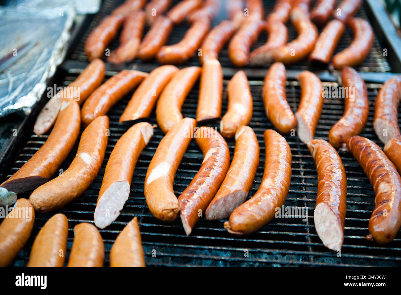 Jumbo hot dogs cooking on a grill Stock Photo Alamy