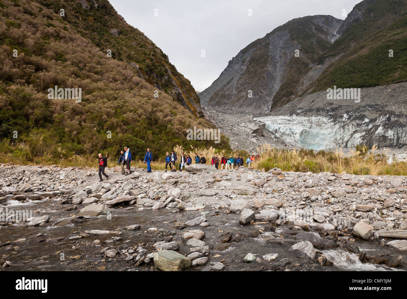 Guided party of tourists leaving the terminal of Fox Glacier, West Coast, New Zealand. Stock Photo