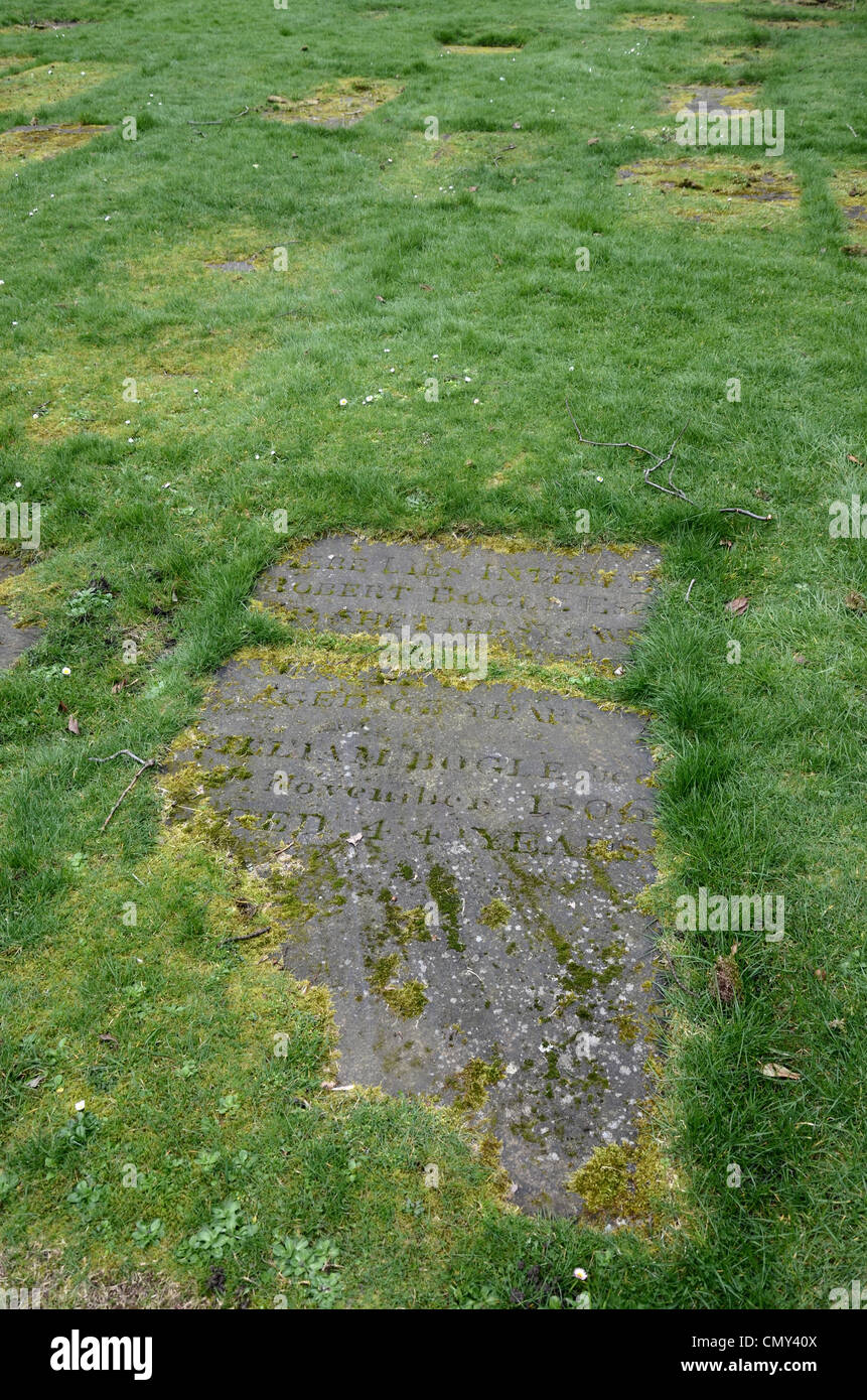 Gravestones just visible through the grass in the graveyard at Glasgow Cathedral, Scotland, UK. Stock Photo
