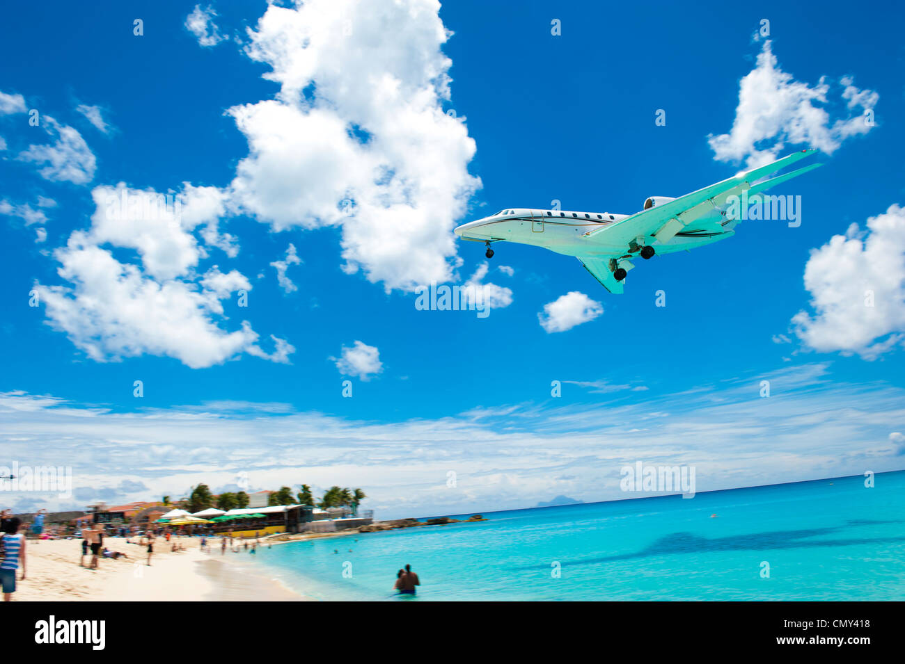 A large airplane landing on a remote island for a vacation. Stock Photo