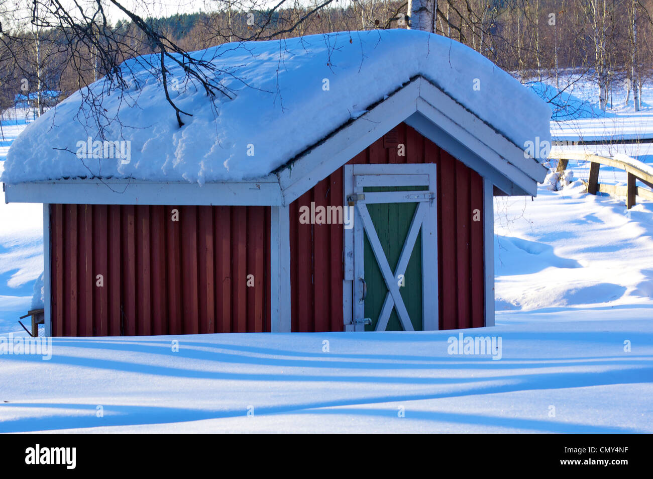 Snow covered red wooden hut Stock Photo - Alamy