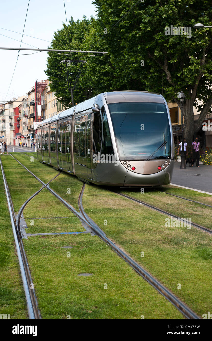 A train traveling along the rail on the grass in Nice, France. Stock Photo