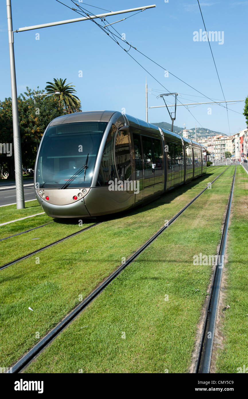 A train traveling along the rail on the grass in Nice, France. Stock Photo