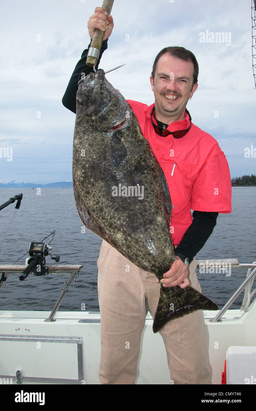 Halibut fisherman with a chicken halibut (small fish of 25 pounds or