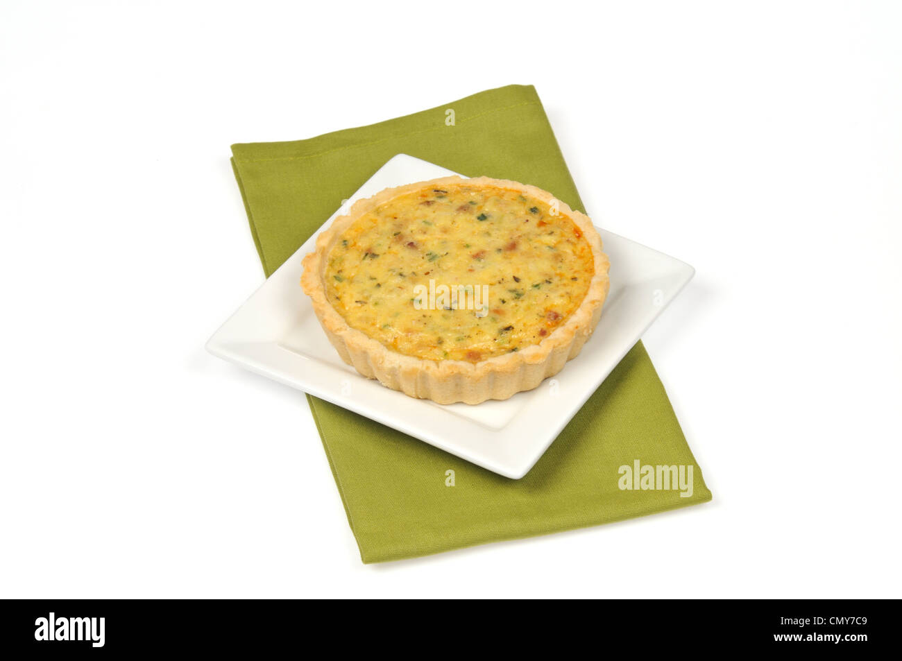 A cooked quiche with ham and cheese on white background cut out Stock Photo