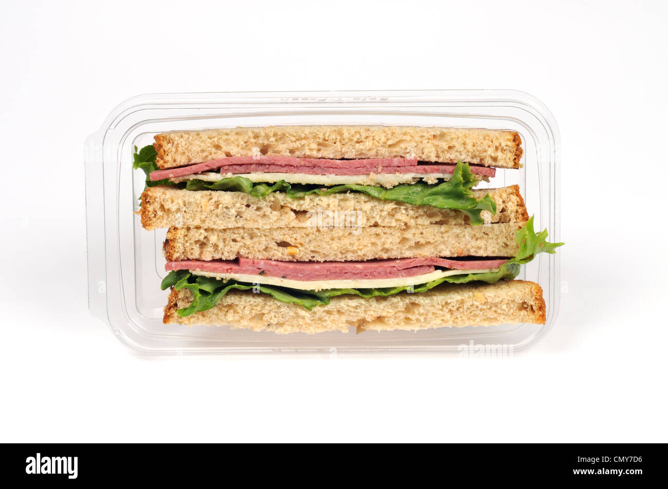 Salami and cheese takeaway sandwich on whole wheat bread with lettuce in packet Stock Photo
