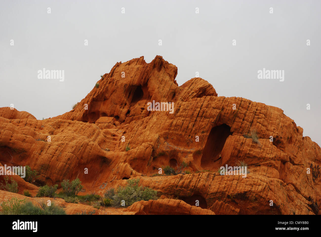 Orange rock under gray sky, Nevada Stock Photo