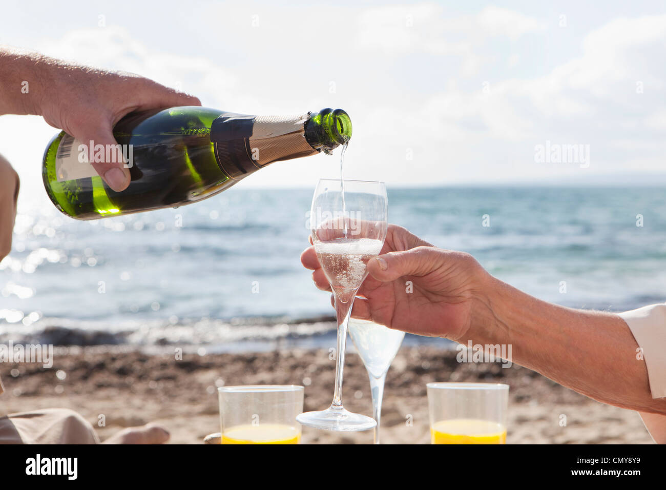 Spain, Mallorca, Senior couple drinking sparkling wine at beach Stock ...