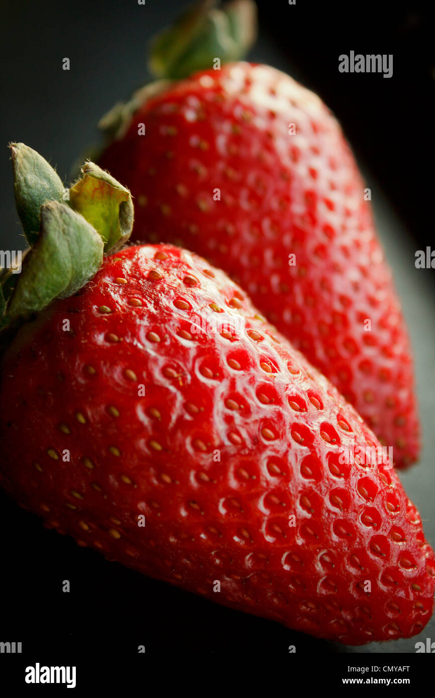 Close-up detail of strawberries with dark background Stock Photo - Alamy