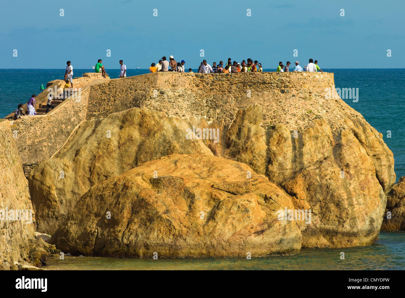 Sightseers gather for sunset on Flag Rock, one of the former Portuguese bastions at the old Dutch Fort; Galle, Sri Lanka, Asia Stock Photo