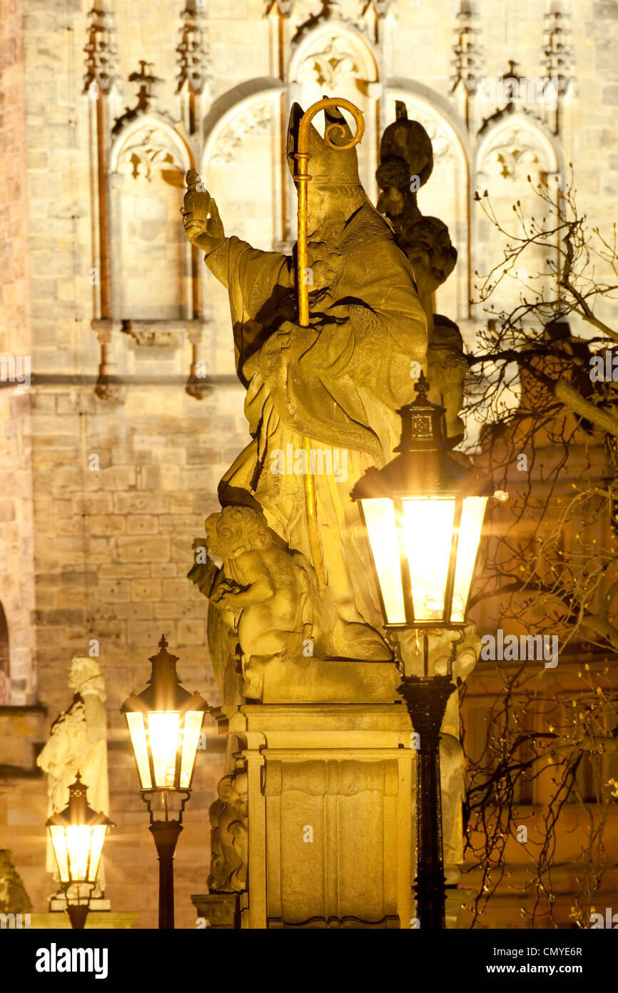 prague - religious art on charles bridge, lanterns and spire. Stock Photo