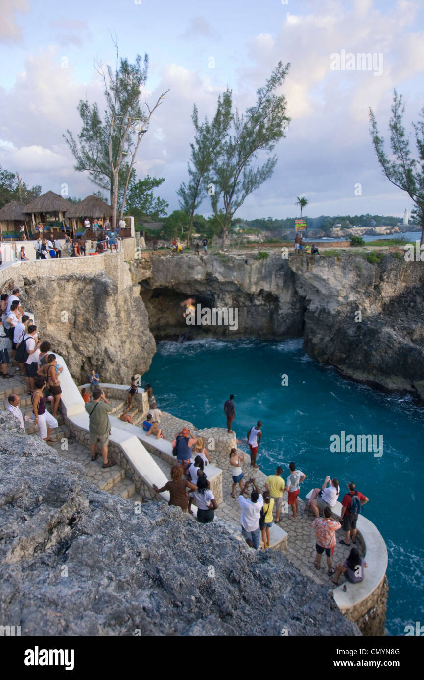 Jamaica Negril Ricks Cafe Cliff Diver jumping from a Tree, crowd Stock