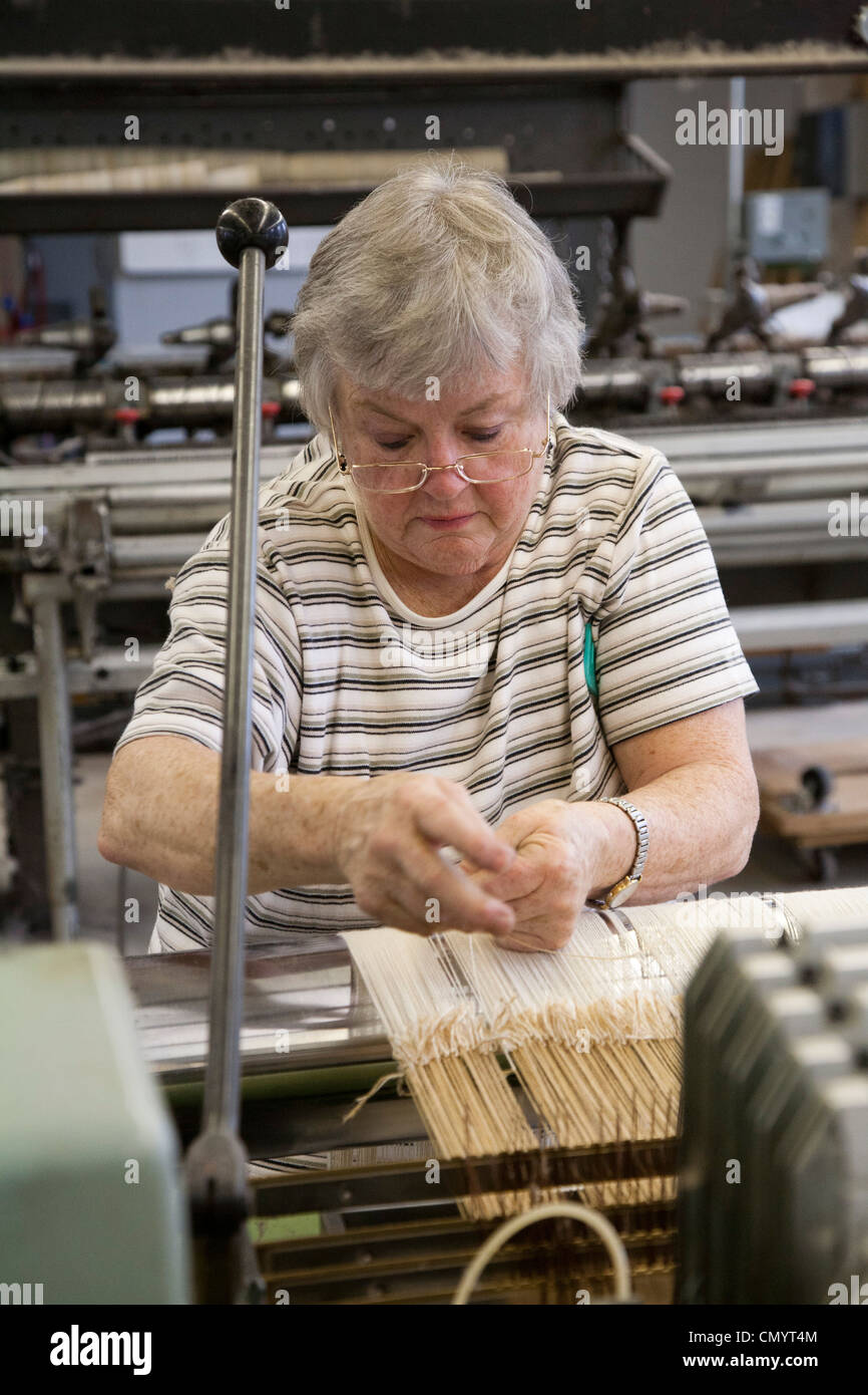 Worker operates a loom at the historic Amana Wollen Mill Stock Photo