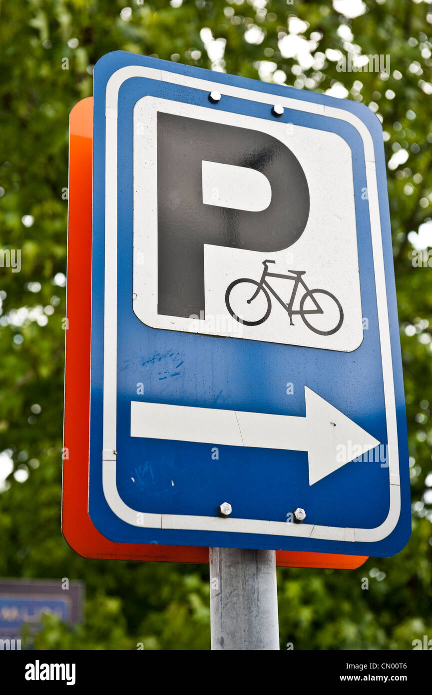 Arrows on a bicycling parking sign pointing to parking areas located in Brussels, Belgium. Stock Photo