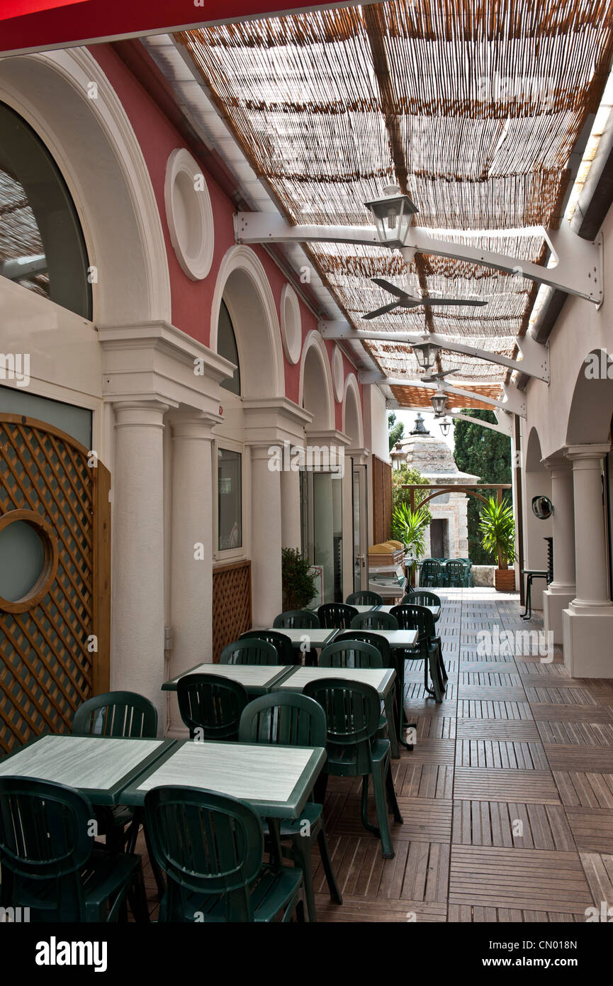 An indoor-outdoor courtyard cafe strip in Monaco. Stock Photo