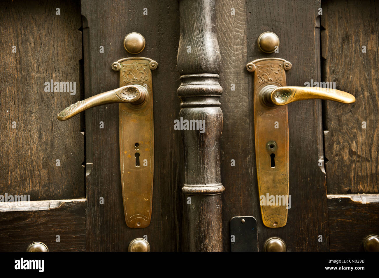 Golden handles on a brown building. Stock Photo