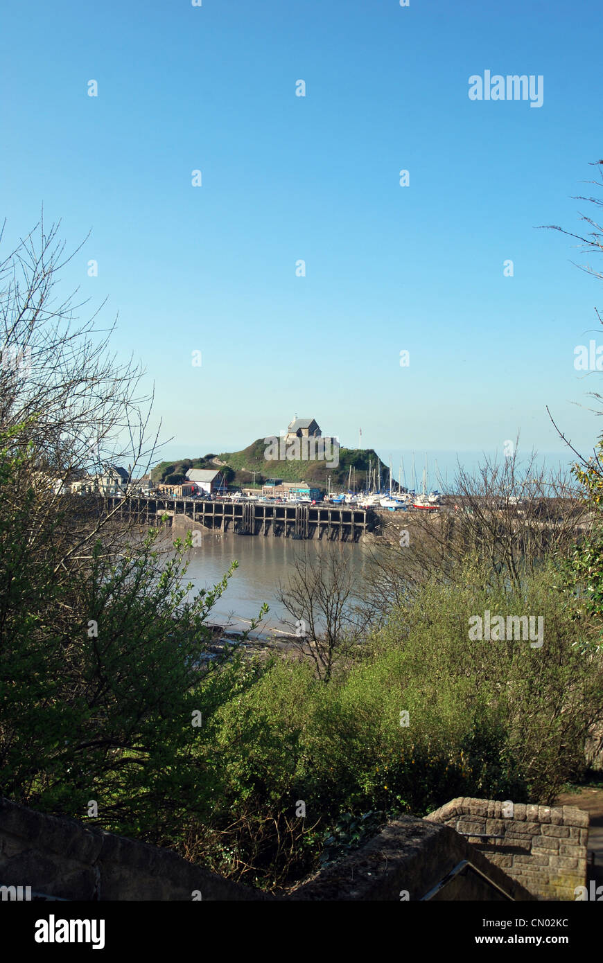 Ilfracombe Harbour in North Devon with the famous Lantern Hill and St Nicholas Chapel overlooking the harbour Stock Photo