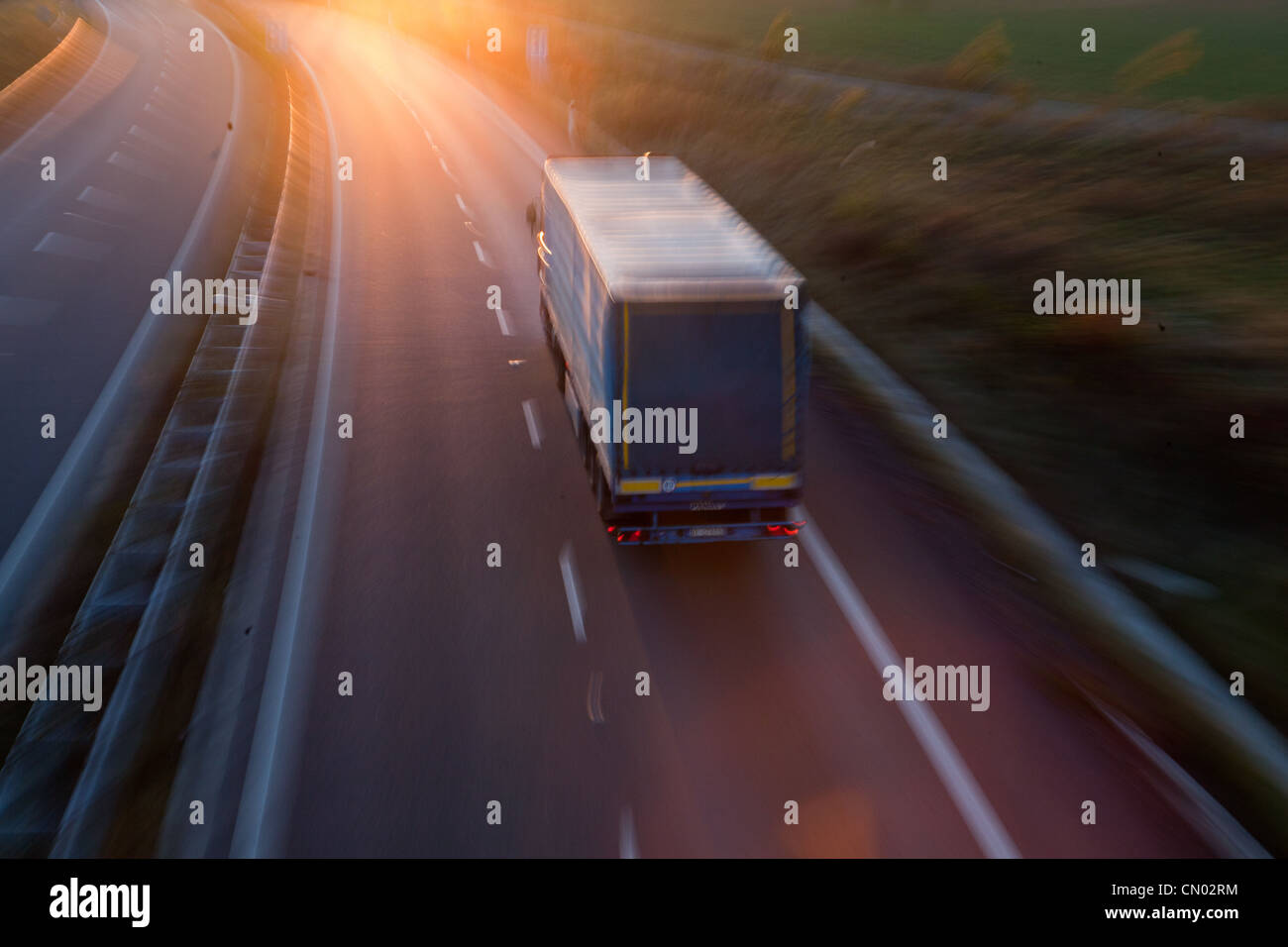 highway traffic - motion blurred truck on a highway/motorway/speedway ...