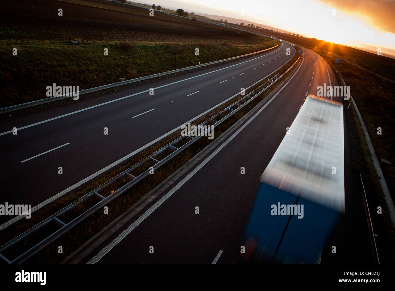 highway traffic - motion blurred truck on a highway/motorway/speedway ...