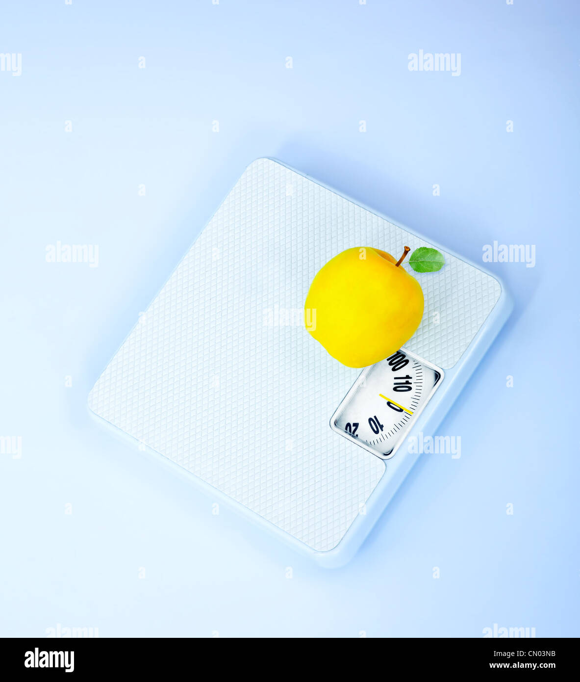 Scales and apple, body weight watching, conceptual image of dieting