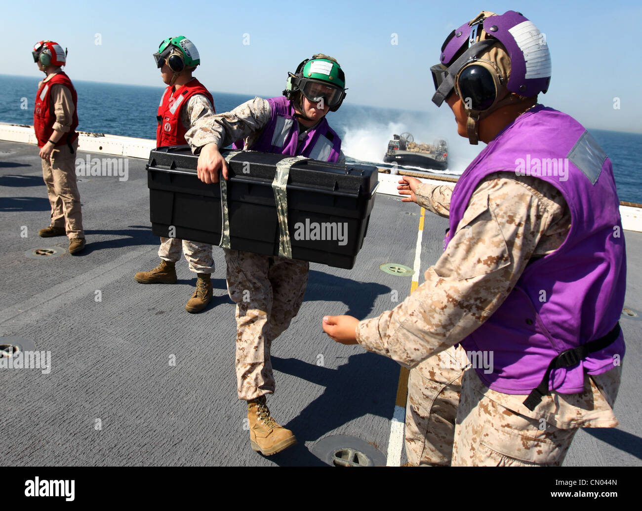 Marines and sailors with the 24th Marine Expeditionary Unit and Iwo Jima Amphibious Ready Group load equipment and supplies onto the USS New York, March 29, 2012, before embarking upon a scheduled eight-month deployment. The 24th MEU, partnered with the Navy's Iwo Jima ARG, is deploying to the European and Central Command theaters of operation to serve as a theater reserve and crisis response force capable of a variety of missions from full-scale combat operations to humanitarian assistance and disaster relief. Stock Photo